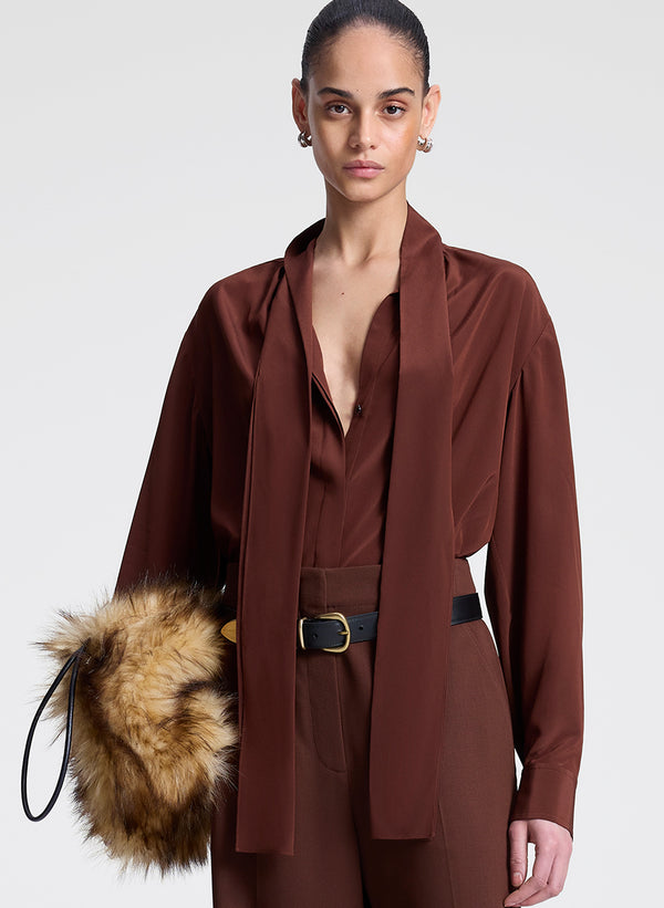 woman wearing brown silk top and matching pants