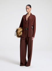 woman wearing brown silk top and matching pants