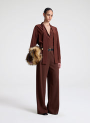 woman wearing brown silk top and matching pants