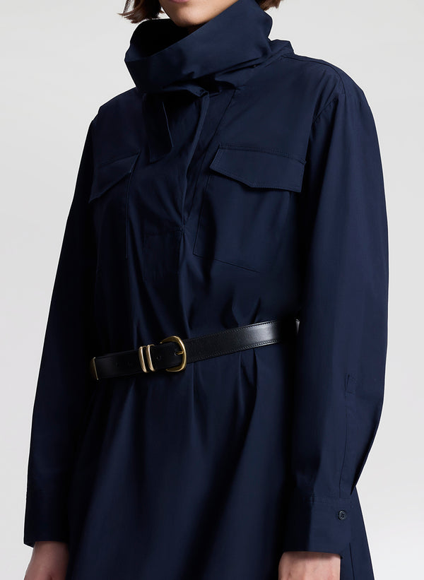 woman wearing navy blue dress with black belt 