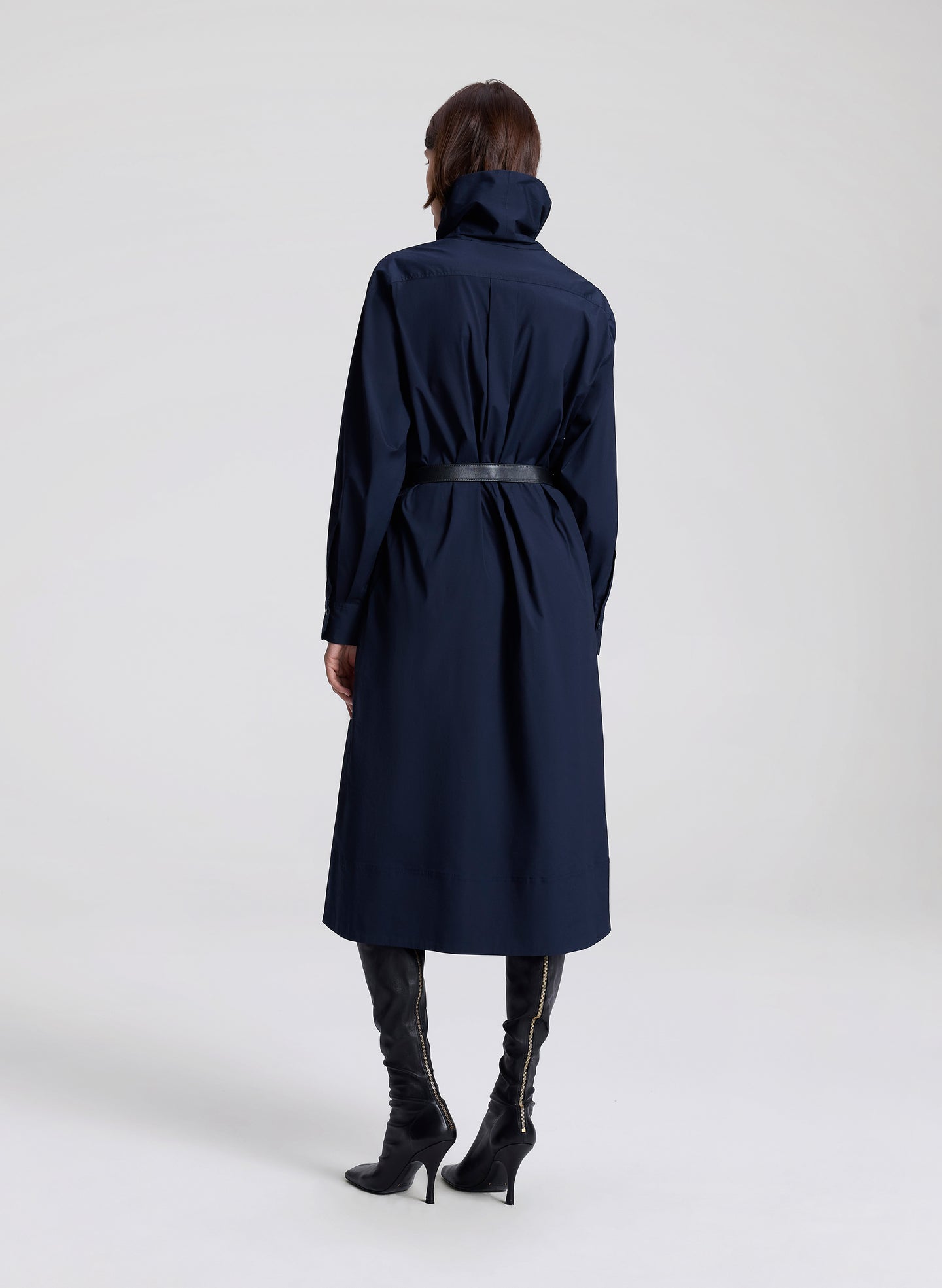 woman wearing navy blue dress with black belt 