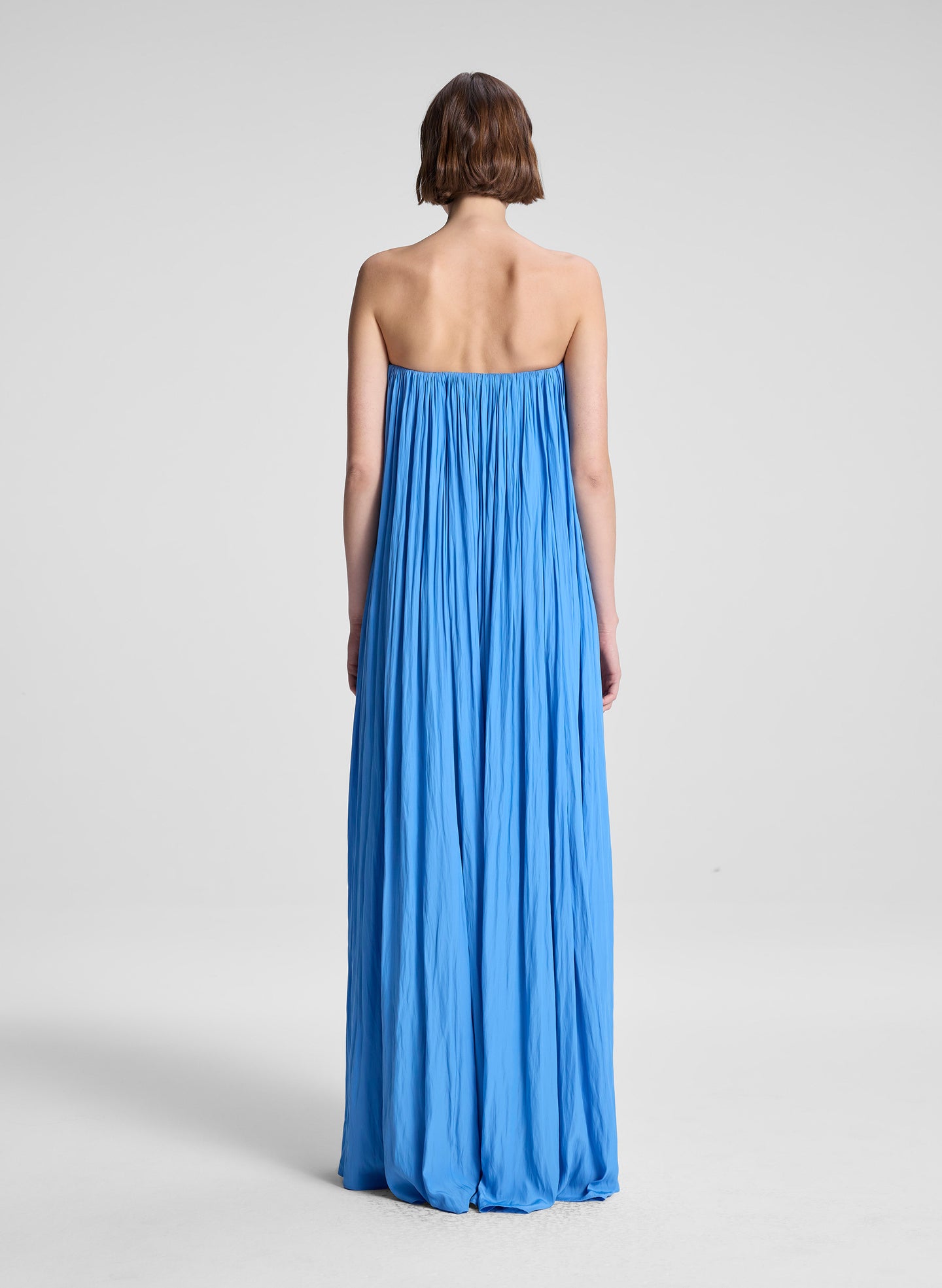 woman wearing blue strapless gown