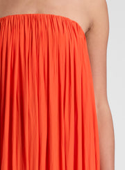 woman wearing orange strapless gown