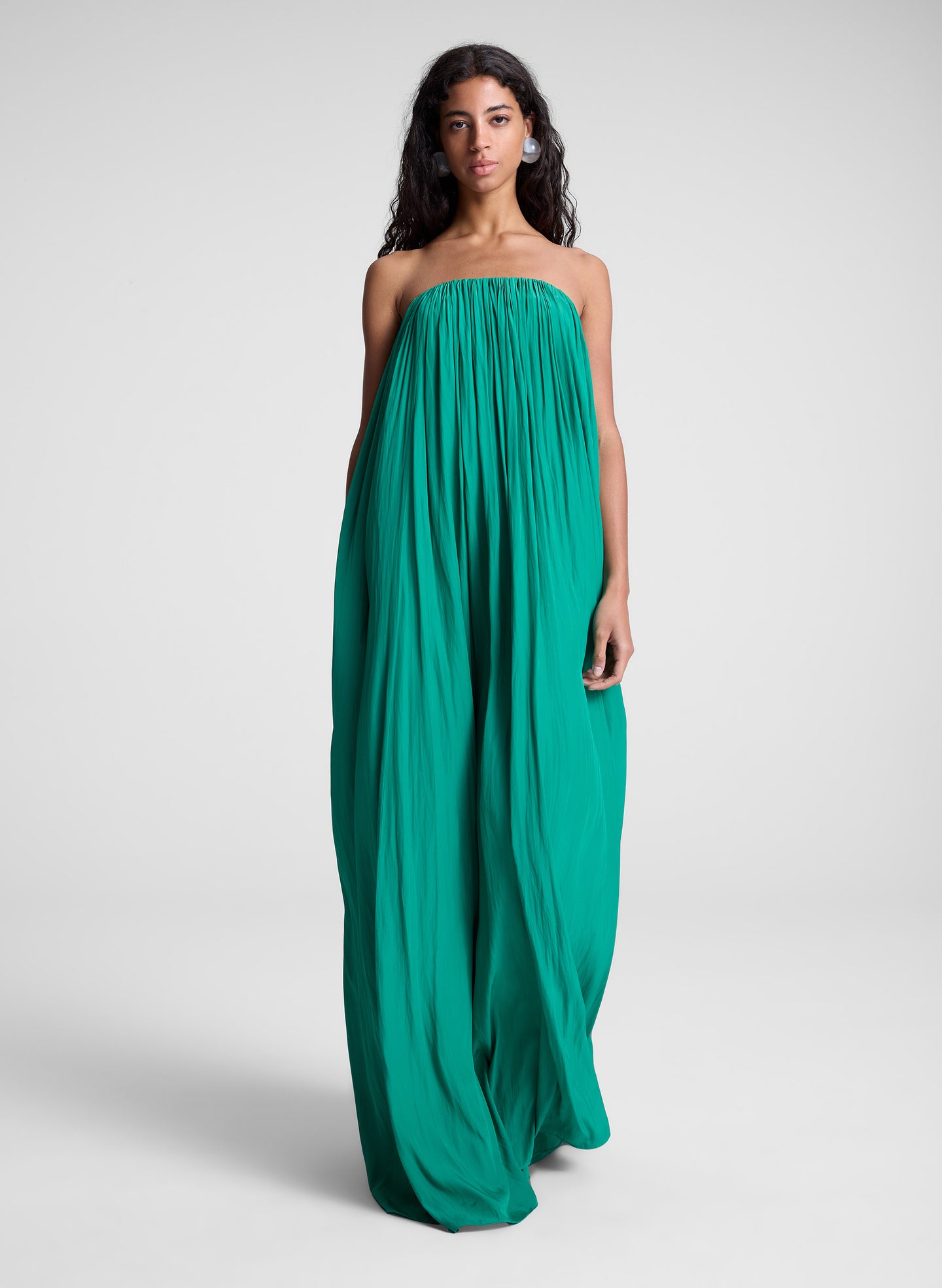 Woman wearing green strapless maxi dress