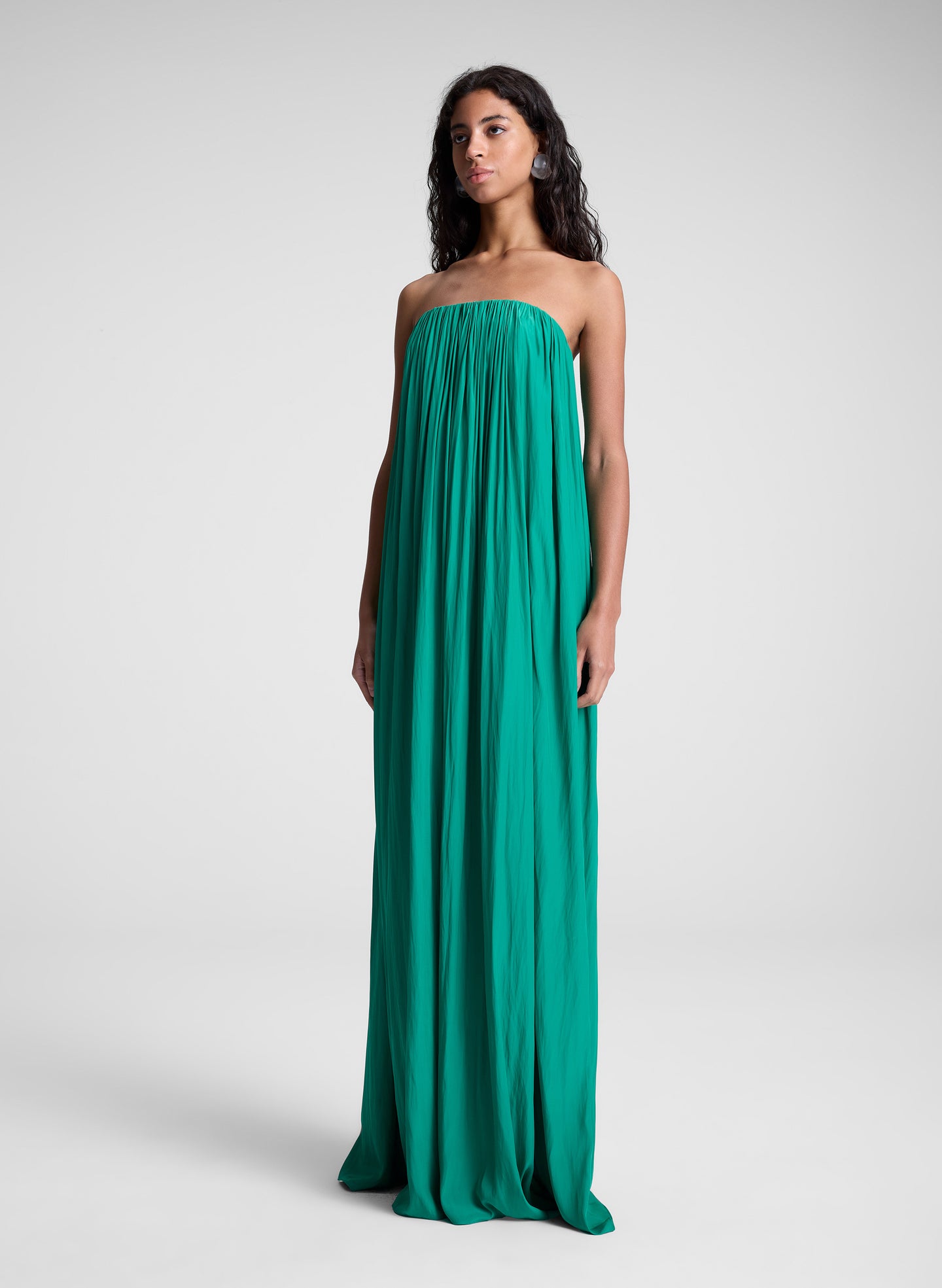Woman wearing green strapless maxi dress