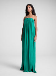 Woman wearing green strapless maxi dress