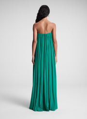 Woman wearing green strapless maxi dress