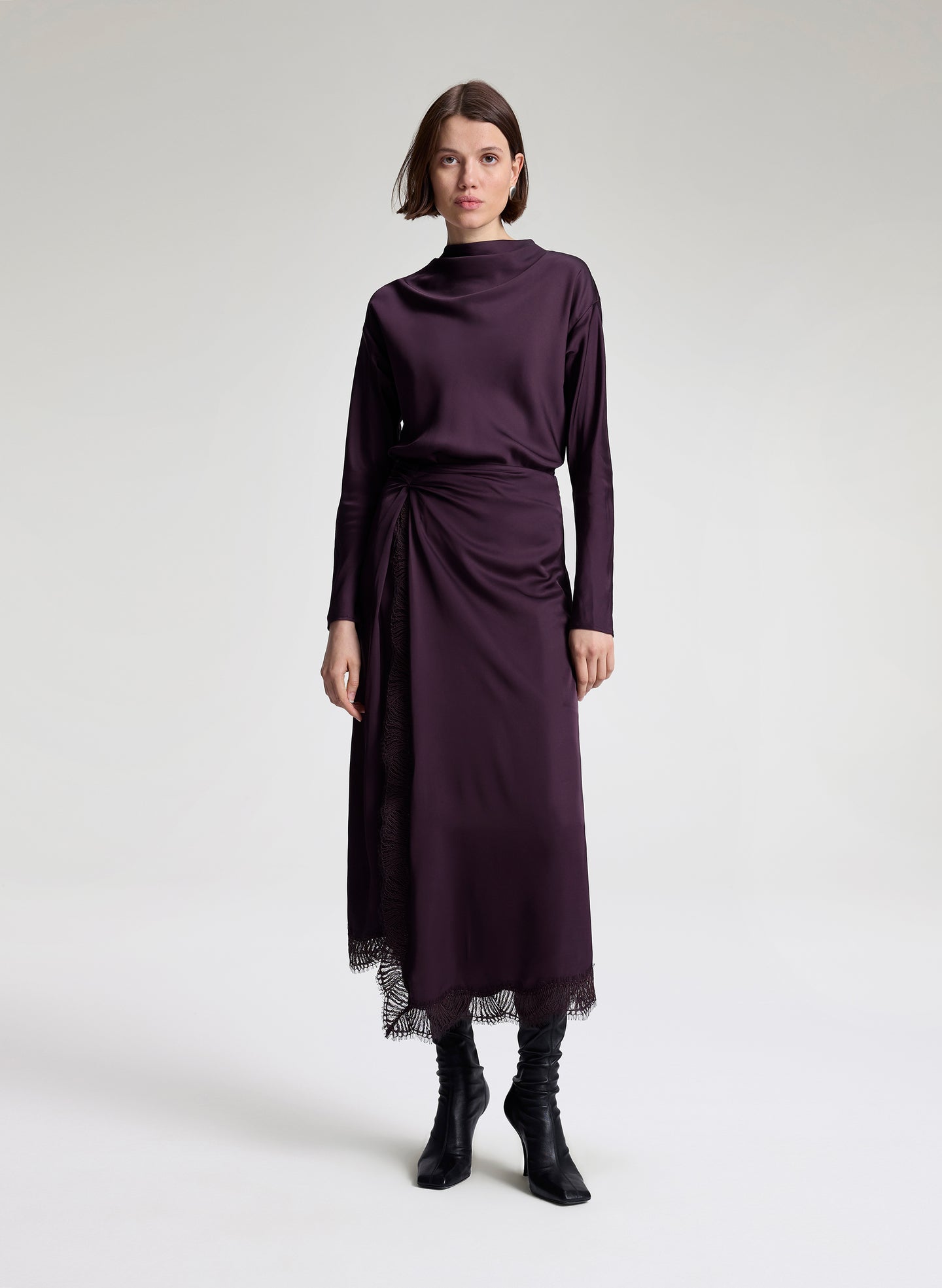 woman wearing purple long sleeve top and matching purple midi skirt