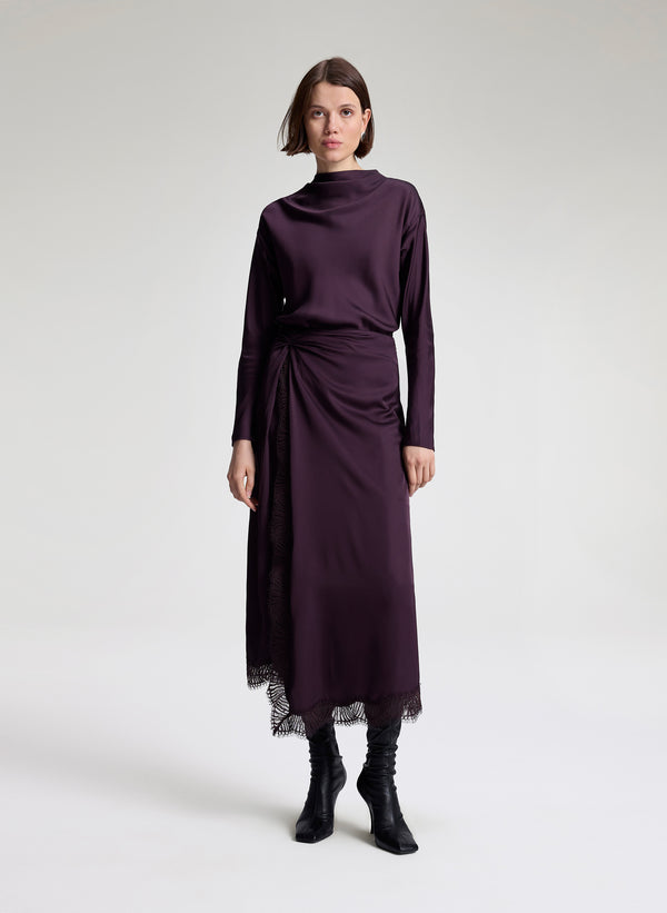 woman wearing purple long sleeve top and matching purple midi skirt