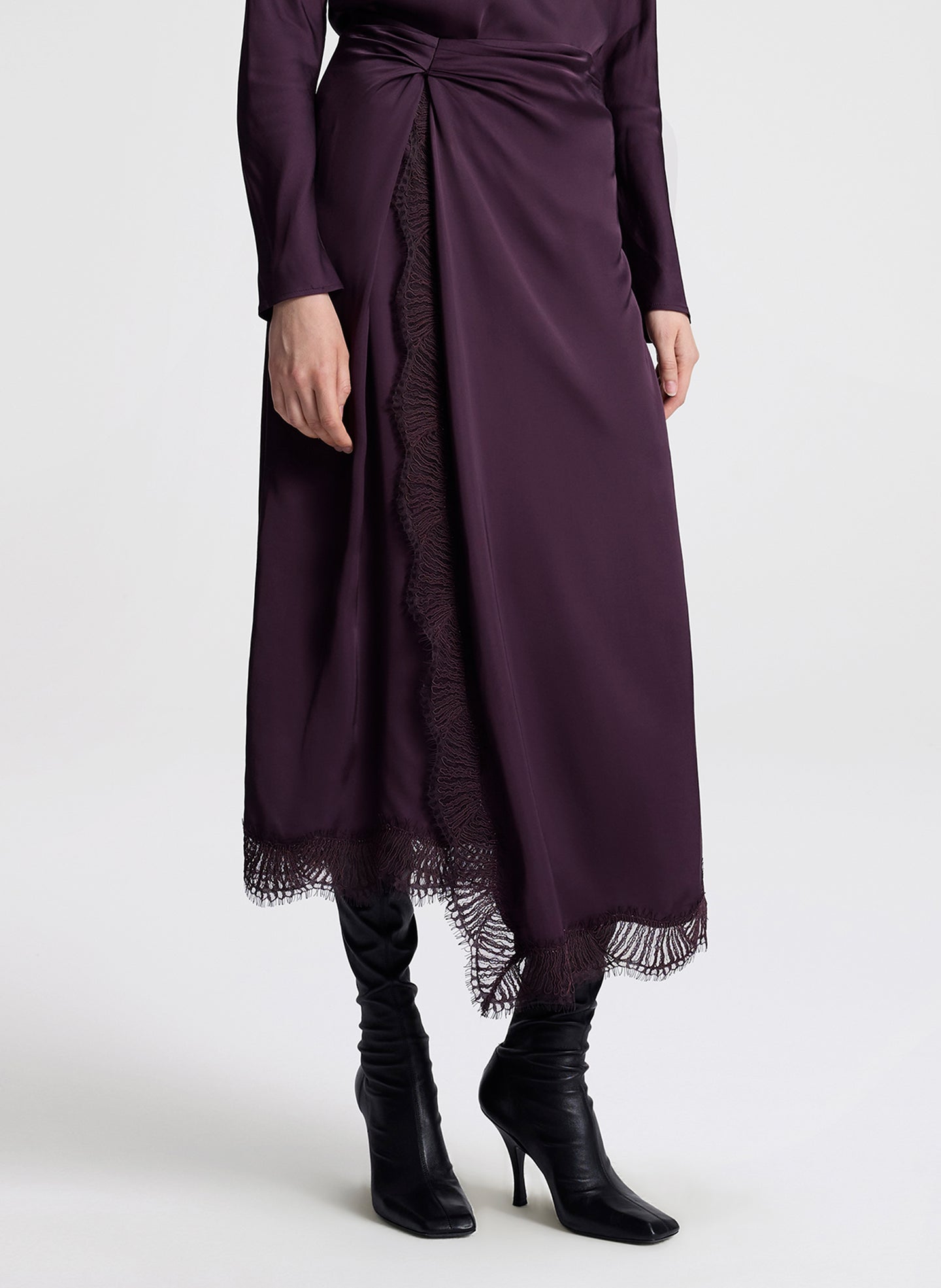 woman wearing purple long sleeve top and matching purple midi skirt