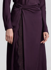 woman wearing purple long sleeve top and matching purple midi skirt