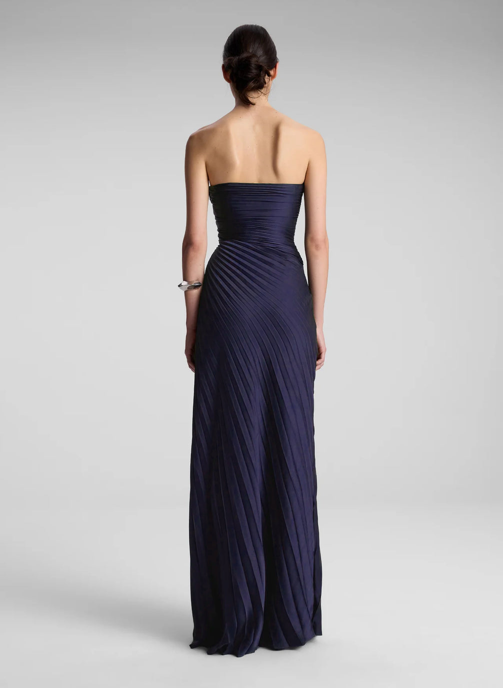 woman wearing navy blue strapless maxi dress