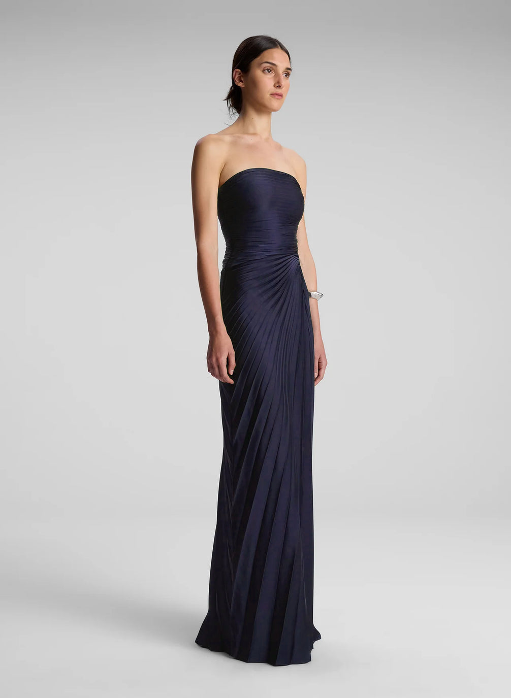 woman wearing navy blue strapless maxi dress