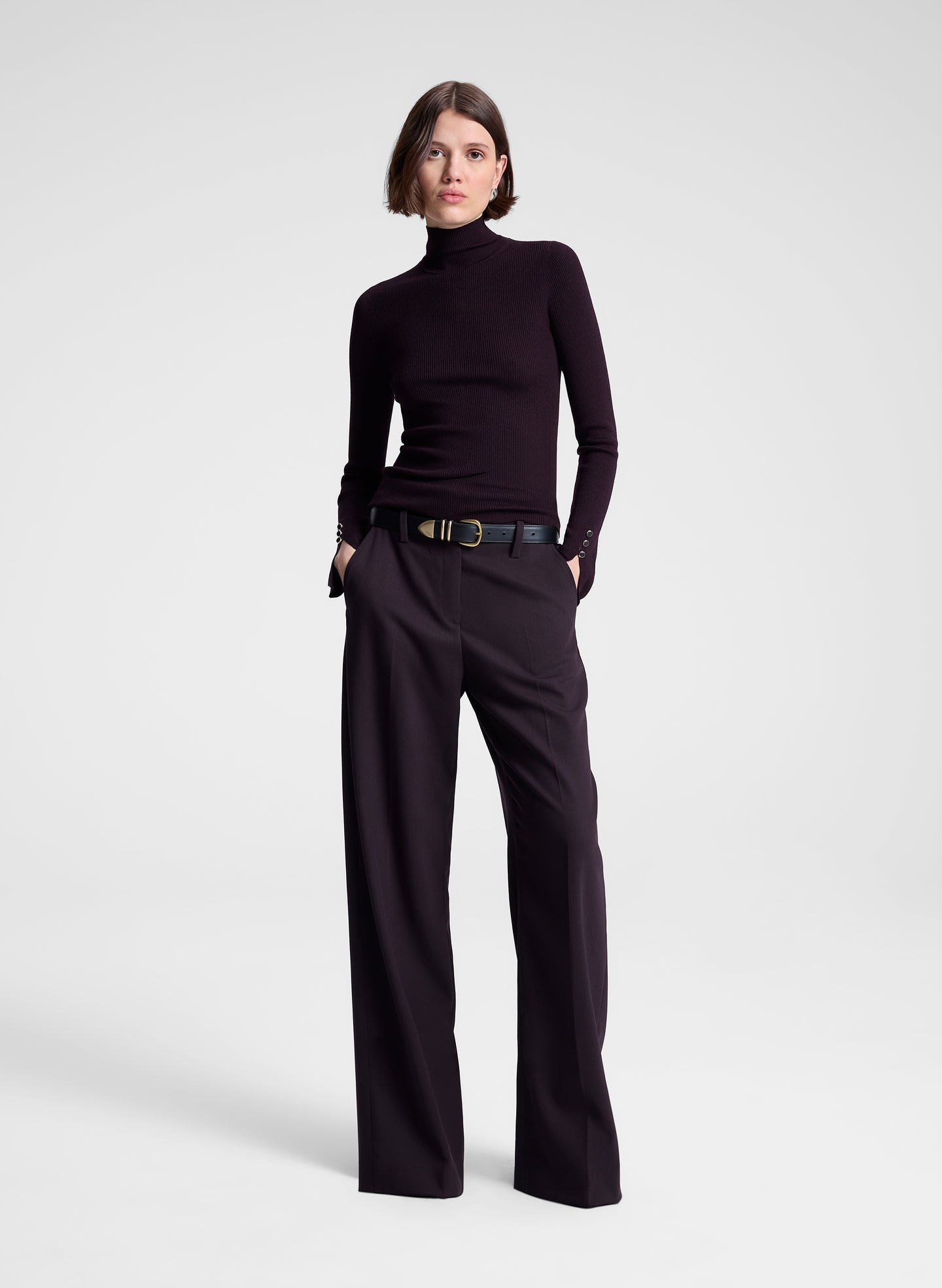 woman wearing purple turtleneck and purple pants 
