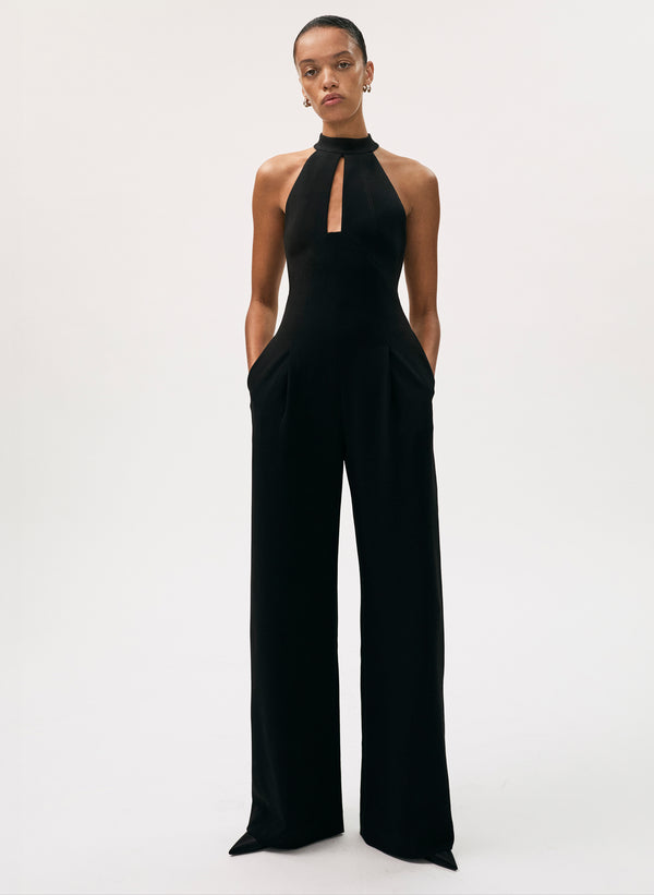 Person wearing a black jumpsuit on a white background