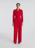 video view of woman wearing red long sleeve jumpsuit with back cutout