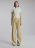 video view of woman wearing white tshirt and beige wide leg pants