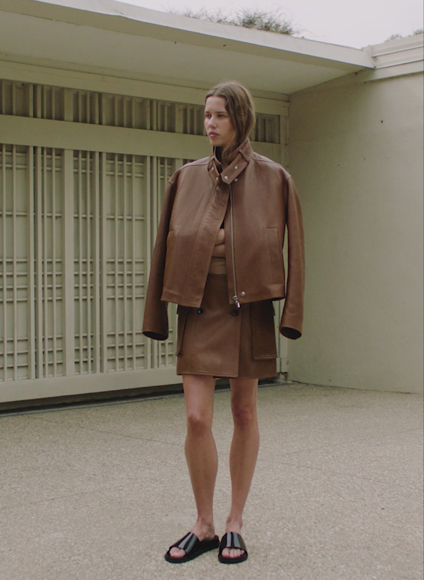 video of a woman wearing a brown leather jacket