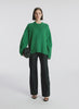 360 degree video view of woman wearing green cashmere long sleeve sweater