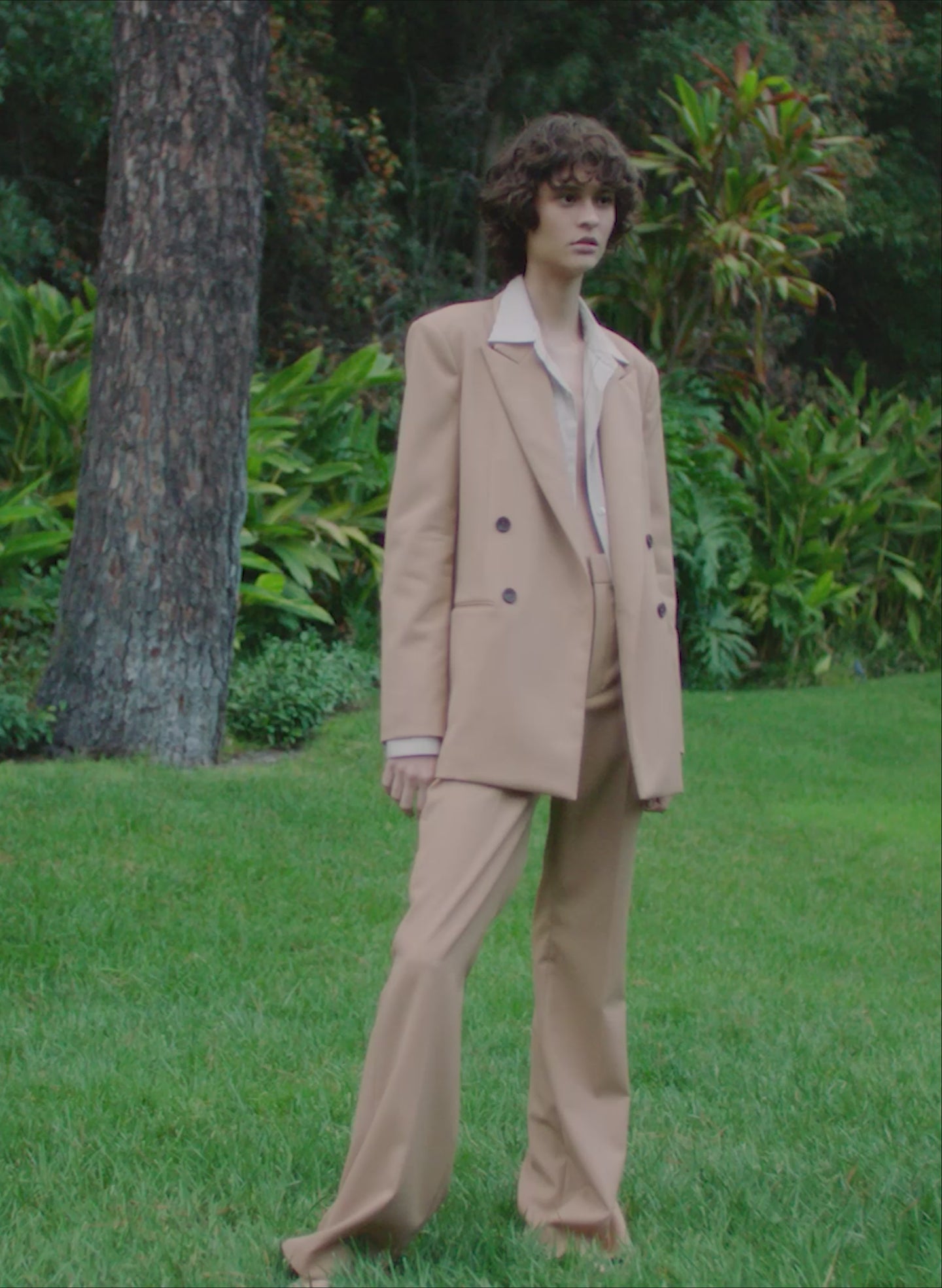 vide of a woman in a desert beige suit
