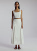video view of woman wearing white sleeveless cropped top and white midi skirt
