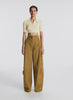 360 view of woman wearing yellow cropped collared shirt and tan cargo pants