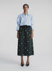 360 view of woman wearing blue embellished button down top and black embellished midi skirt