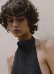 woman wearing black pleated gown