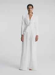 video view of woman wearing white long sleeve jumpsuit