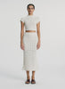 video view of woman wearing cream open weave cropped top and and matching midi skirt