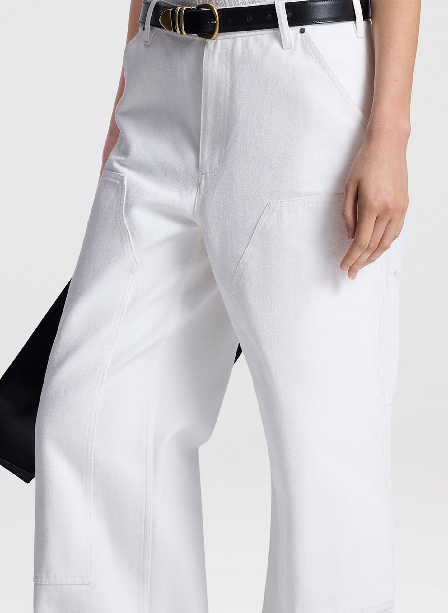 White pants with a black belt on a white background