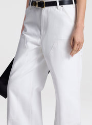 White pants with a black belt on a white background