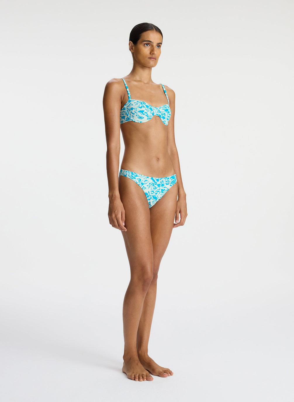 side view of woman wearing aqua printed bikini set