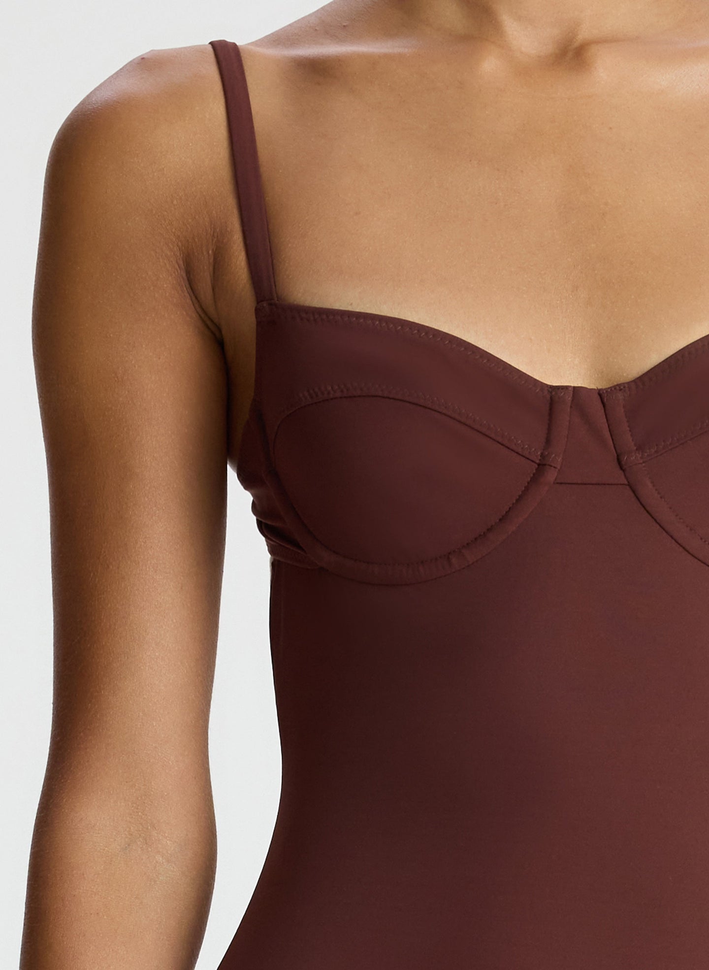detail view of woman wearing brown one piece swimsuit