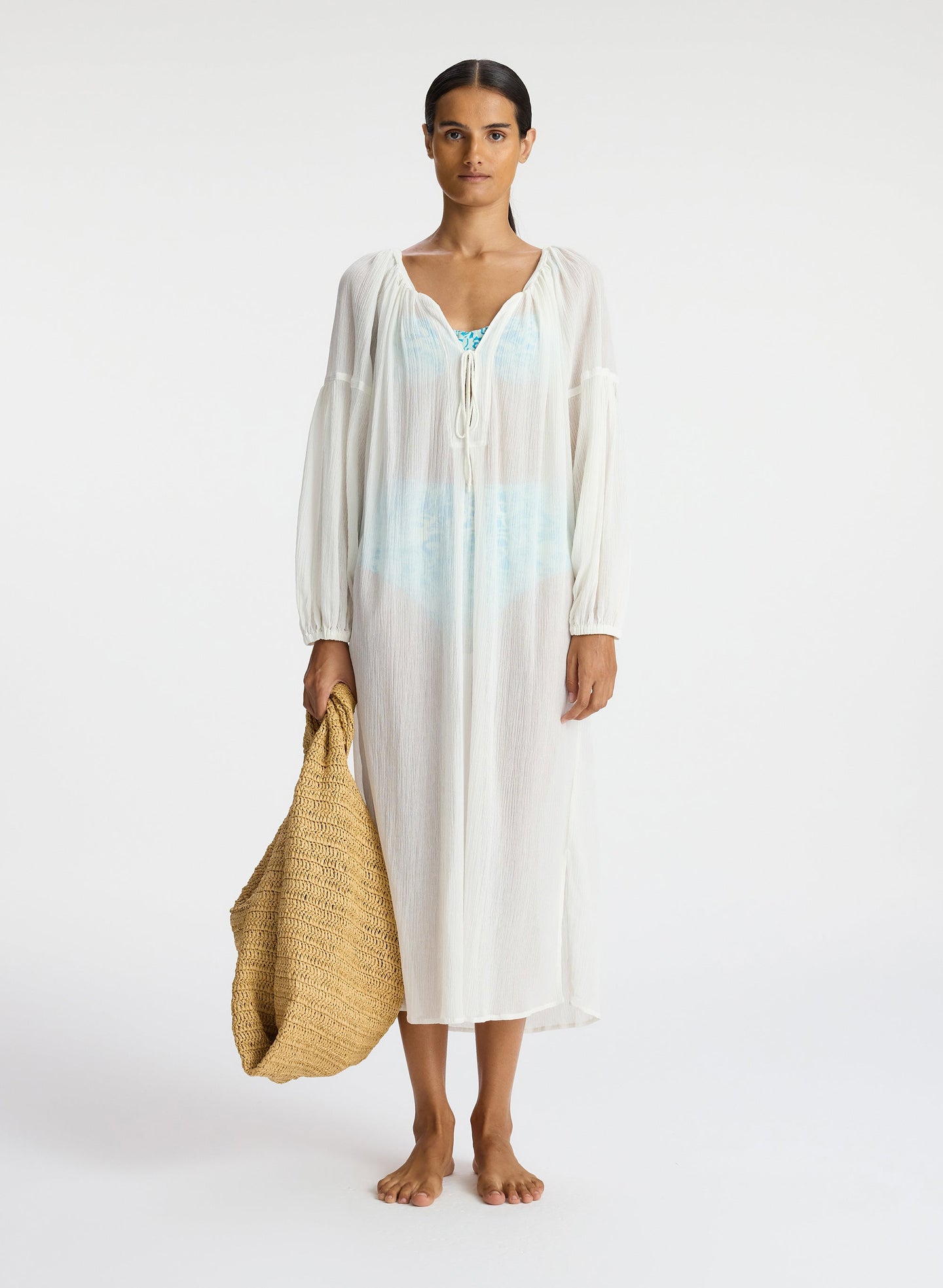 front view of woman wearing white sheer swim cover up dress