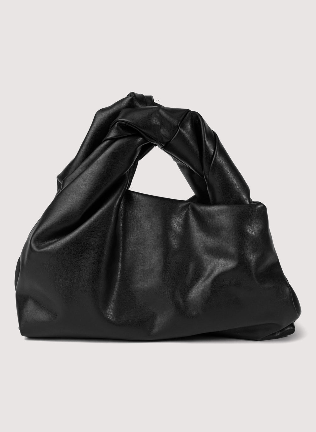 flat lay view of black vegan leather short length top handle bag with small sized rectangular base