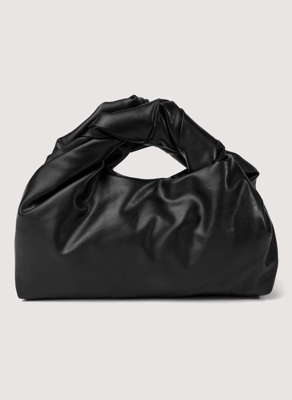 flat lay view of black vegan leather short length top handle bag with small sized rectangular base
