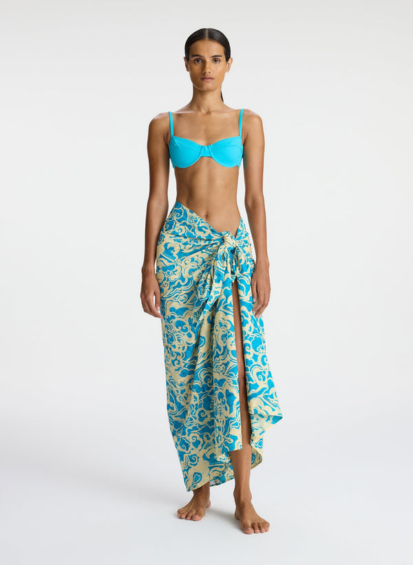 front view of woman wearing aqua bikini and aqua print sarong
